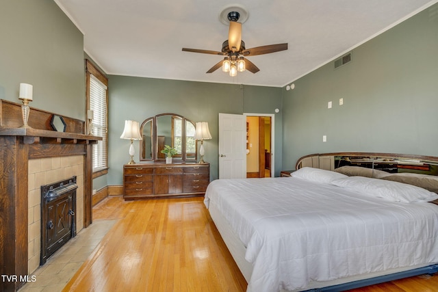 522 Alabama St, Bristol, TN 37620 - bedroom featuring light wood finished floors, a tiled fireplace, and a ceiling fan