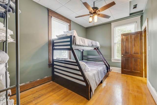 522 Alabama St, Bristol, TN 37620 - bedroom featuring light wood-type flooring, multiple windows, a drop ceiling, and ceiling fan