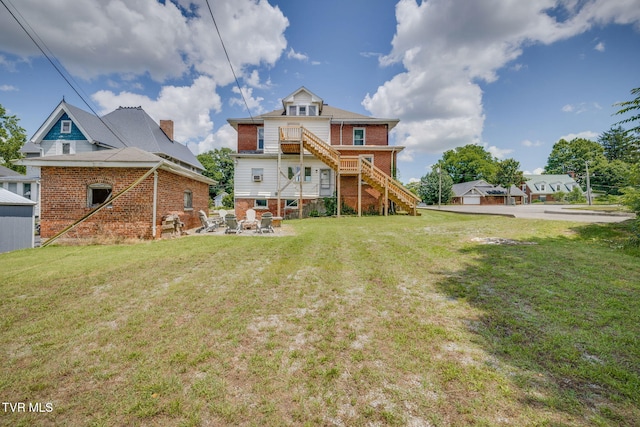 522 Alabama St, Bristol, TN 37620 - rear view of house with brick siding, stairway, a lawn, and a patio area