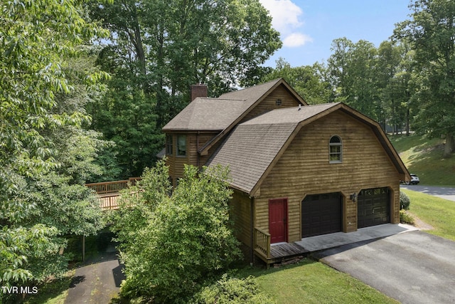 2019 Ridgeview Dr, Big Stone Gap, VA 24219 - view of home's exterior with a gambrel roof, a garage, asphalt driveway, a chimney, and a wooden deck