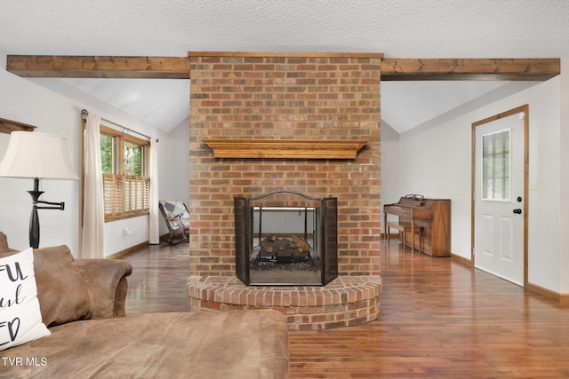 2019 Ridgeview Dr, Big Stone Gap, VA 24219 - living area featuring wood finished floors, a brick fireplace, and a textured ceiling