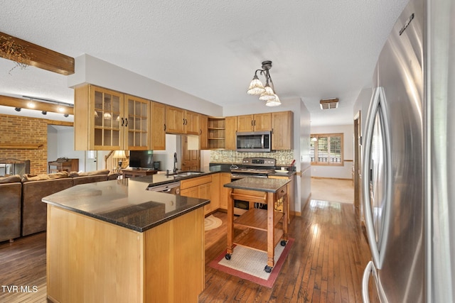 2019 Ridgeview Dr, Big Stone Gap, VA 24219 - kitchen with stainless steel appliances, open shelves, dark wood-style floors, glass insert cabinets, and decorative light fixtures