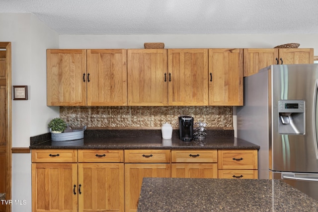 2019 Ridgeview Dr, Big Stone Gap, VA 24219 - kitchen with stainless steel fridge, a textured ceiling, tasteful backsplash, and dark stone countertops