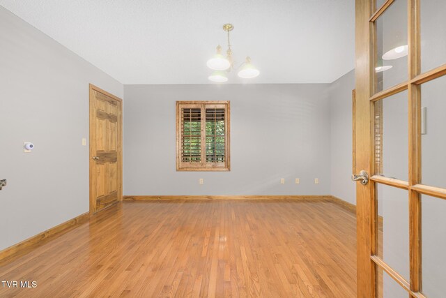2019 Ridgeview Dr, Big Stone Gap, VA 24219 - empty room featuring light wood-type flooring and a chandelier