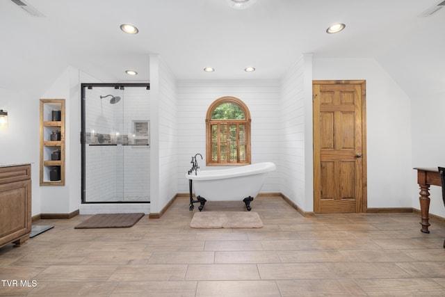 2019 Ridgeview Dr, Big Stone Gap, VA 24219 - bathroom with a stall shower, a freestanding tub, recessed lighting, wood finished floors, and vanity