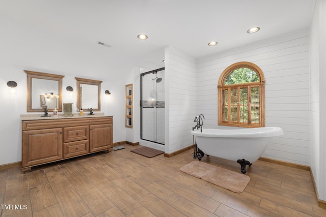 2019 Ridgeview Dr, Big Stone Gap, VA 24219 - full bathroom with a freestanding bath, a shower stall, double vanity, wood finished floors, and recessed lighting