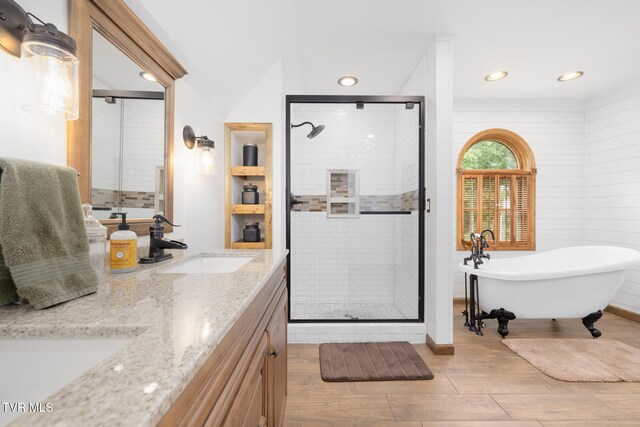 2019 Ridgeview Dr, Big Stone Gap, VA 24219 - bathroom with a stall shower, wood finished floors, a freestanding tub, double vanity, and recessed lighting