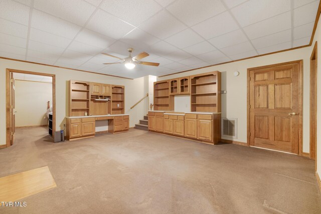 2019 Ridgeview Dr, Big Stone Gap, VA 24219 - unfurnished living room featuring light carpet, ceiling fan, a paneled ceiling, and built in study area