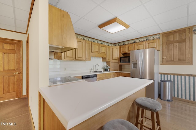 2019 Ridgeview Dr, Big Stone Gap, VA 24219 - kitchen featuring stainless steel appliances, a peninsula, a breakfast bar area, premium range hood, and light countertops