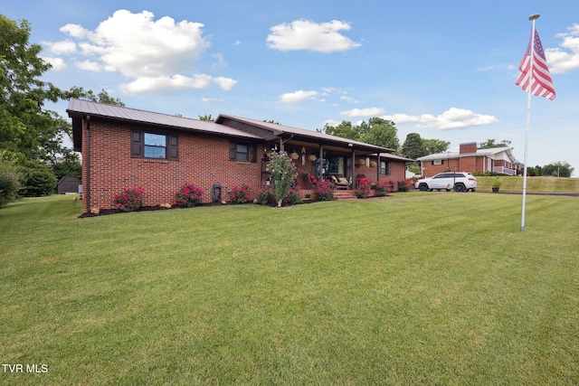 188 Mcarthur Cir, Bristol, VA 24201 - view of front of property with covered porch, a front yard, brick siding, and a metal roof
