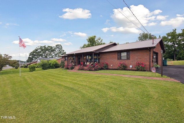 188 Mcarthur Cir, Bristol, VA 24201 - view of front facade featuring a front yard, brick siding, a metal roof, a porch, and driveway