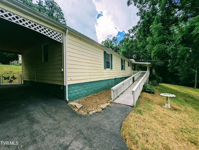 222 Warren Dr, Big Stone Gap, VA 24219 - view of side of property featuring asphalt driveway, a yard, and an attached carport