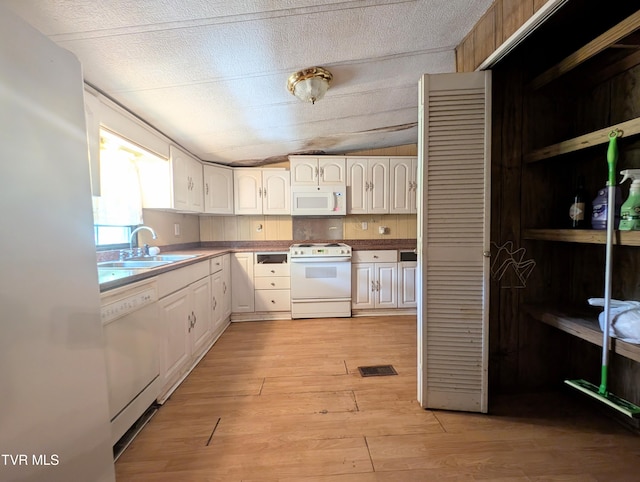 222 Warren Dr, Big Stone Gap, VA 24219 - kitchen featuring white appliances, light wood finished floors, white cabinetry, and vaulted ceiling