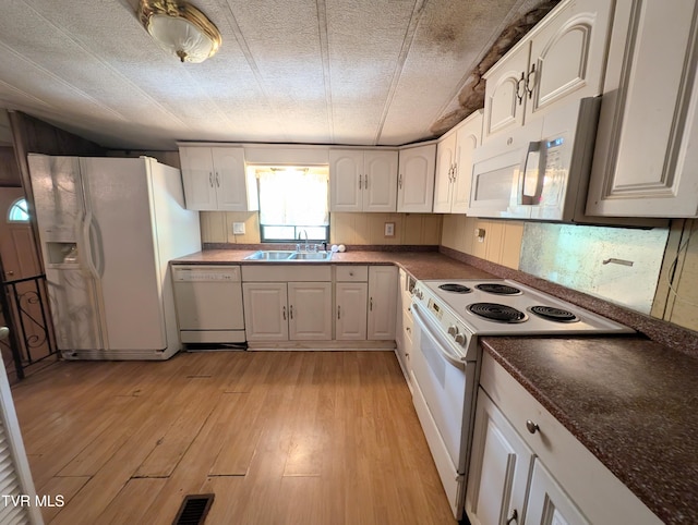 222 Warren Dr, Big Stone Gap, VA 24219 - kitchen featuring white appliances, dark countertops, white cabinets, and light wood finished floors