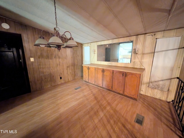 222 Warren Dr, Big Stone Gap, VA 24219 - unfurnished dining area with light wood-type flooring, wooden walls, a chandelier, and lofted ceiling