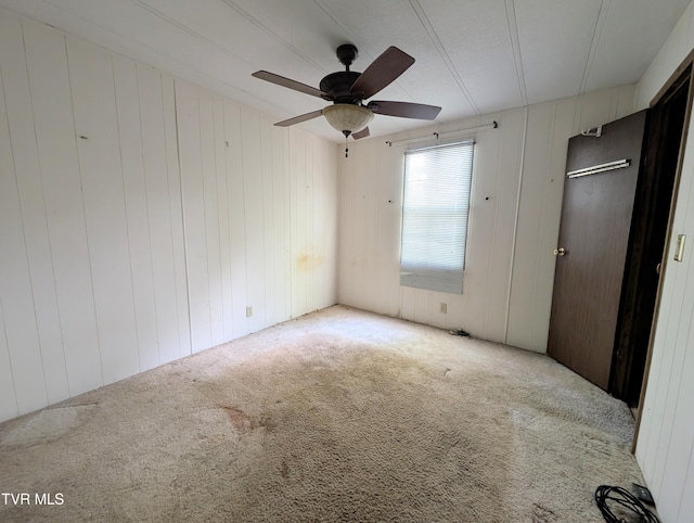 222 Warren Dr, Big Stone Gap, VA 24219 - unfurnished bedroom featuring carpet floors, ceiling fan, and wooden walls