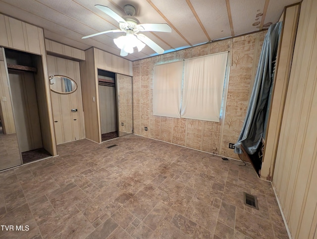 222 Warren Dr, Big Stone Gap, VA 24219 - unfurnished bedroom with two closets, stone finish floors, and a ceiling fan