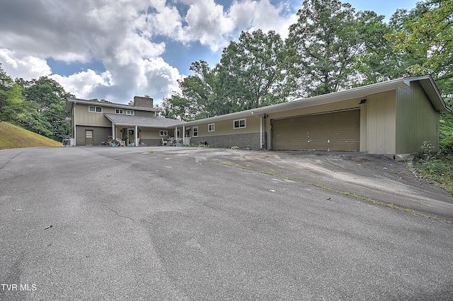 1108 Glen St, Bristol, TN 37620 - view of front of property with a chimney, asphalt driveway, and a garage
