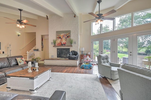 1108 Glen St, Bristol, TN 37620 - living room featuring ceiling fan, a high ceiling, stairs, hardwood / wood-style flooring, and beam ceiling