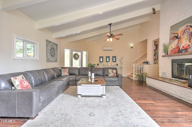 1108 Glen St, Bristol, TN 37620 - living room featuring stairway, dark wood-style floors, ceiling fan, a wall unit AC, and a fireplace