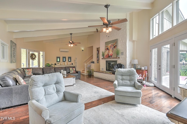 1108 Glen St, Bristol, TN 37620 - living area featuring a ceiling fan, wood finished floors, beamed ceiling, a wall unit AC, and high vaulted ceiling