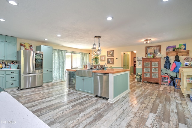 1108 Glen St, Bristol, TN 37620 - kitchen featuring stainless steel appliances, beverage cooler, light wood finished floors, wooden counters, and recessed lighting