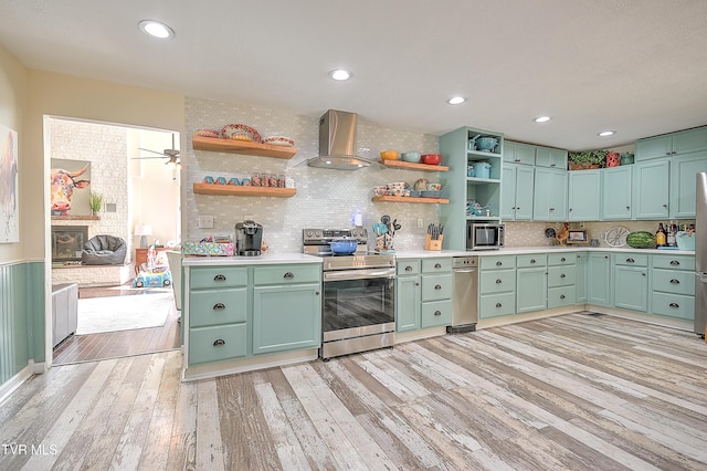 1108 Glen St, Bristol, TN 37620 - kitchen featuring appliances with stainless steel finishes, open shelves, wall chimney range hood, light wood-style floors, and recessed lighting