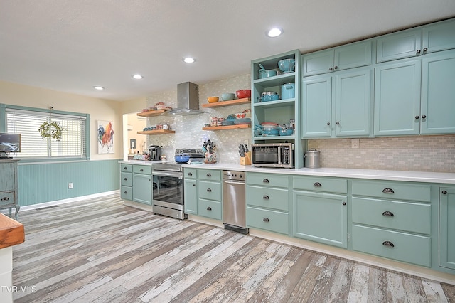 1108 Glen St, Bristol, TN 37620 - kitchen with stainless steel appliances, wall chimney exhaust hood, open shelves, green cabinets, and light wood-type flooring