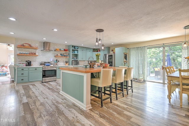 1108 Glen St, Bristol, TN 37620 - kitchen with stainless steel appliances, open shelves, green cabinetry, wooden counters, and a textured ceiling