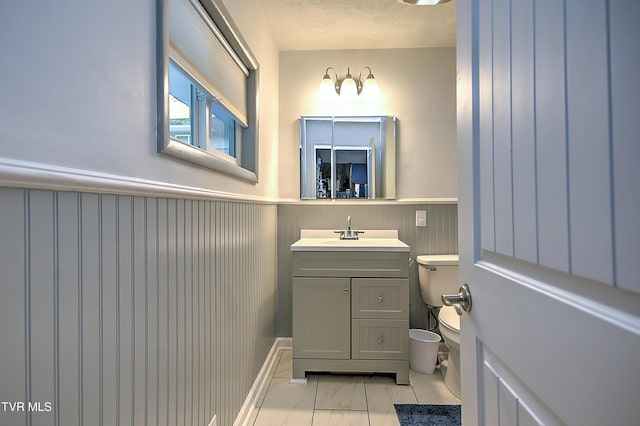 1108 Glen St, Bristol, TN 37620 - bathroom featuring a wainscoted wall, vanity, and marble look tile flooring