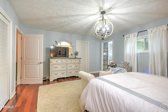1108 Glen St, Bristol, TN 37620 - bedroom featuring a chandelier, dark wood-type flooring, and a textured ceiling