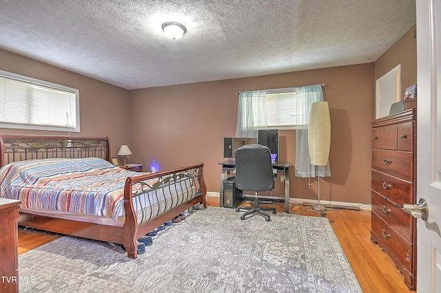 1108 Glen St, Bristol, TN 37620 - bedroom featuring wood finished floors, a textured ceiling, and an office area