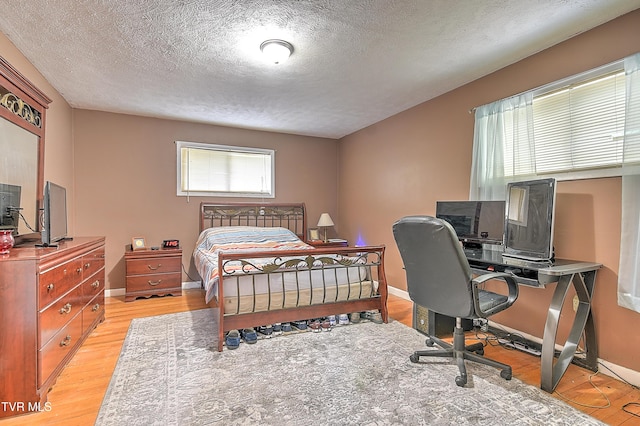 1108 Glen St, Bristol, TN 37620 - bedroom with light wood finished floors, a textured ceiling, and a desk