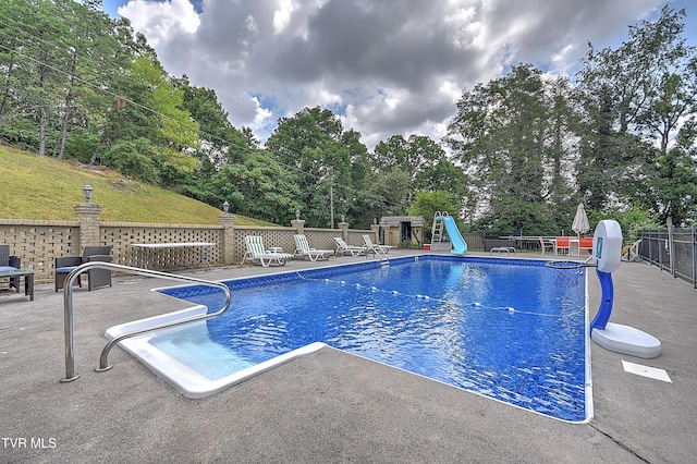 1108 Glen St, Bristol, TN 37620 - view of swimming pool with a water slide, a patio, and view of wooded area