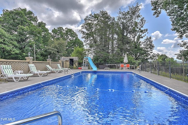 1108 Glen St, Bristol, TN 37620 - view of swimming pool featuring a water slide, a patio area, and view of scattered trees