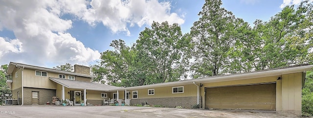 1108 Glen St, Bristol, TN 37620 - view of front facade featuring concrete driveway, a chimney, a garage, and stone siding