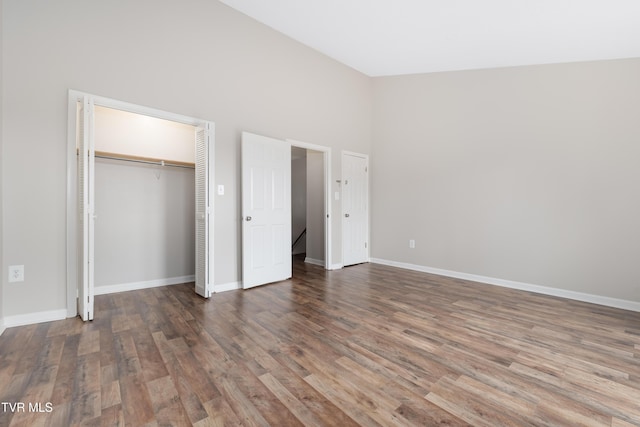 182 Sierra Pl Unit 182, Bristol, VA 24201 - unfurnished bedroom featuring wood finished floors, a closet, and a towering ceiling
