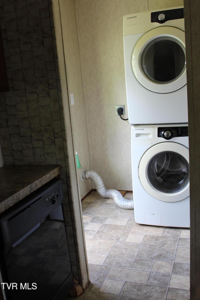 402 Beeline Rd, Duffield, VA 24244 - washroom featuring stacked washing machine and dryer and stone finish floors