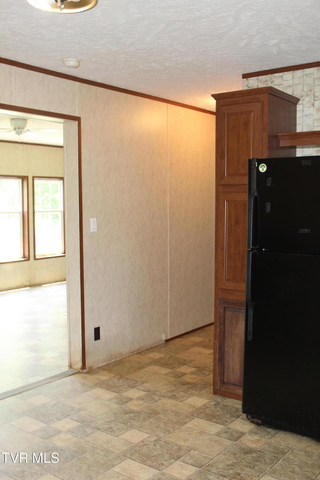 402 Beeline Rd, Duffield, VA 24244 - kitchen with freestanding refrigerator, crown molding, a textured ceiling, and brown cabinetry