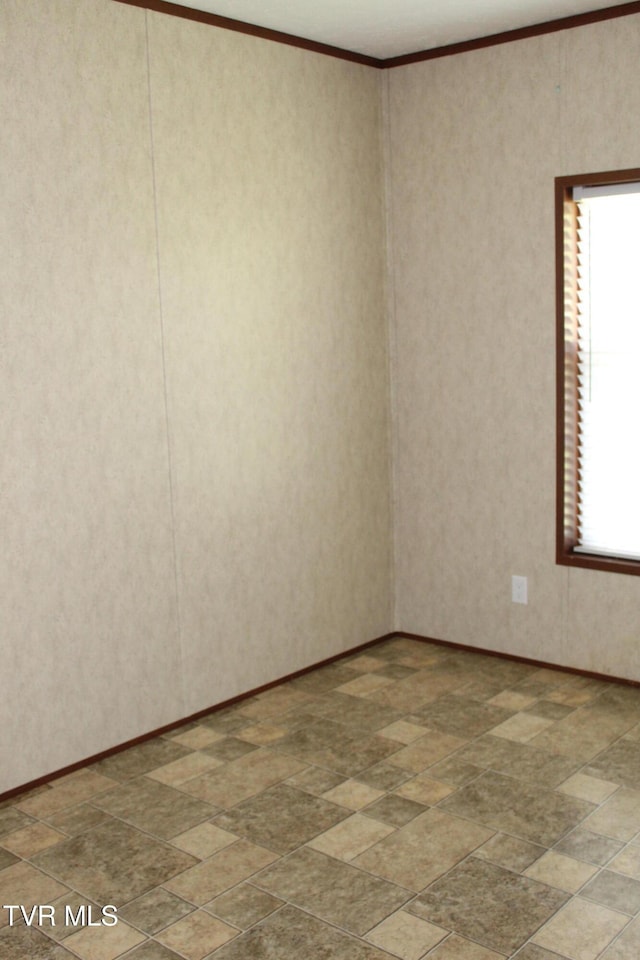 402 Beeline Rd, Duffield, VA 24244 - spare room featuring crown molding and stone finish floors