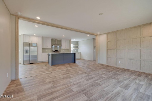 106 Iris Ln, Fall Branch, TN 37656 - kitchen with stainless steel fridge with ice dispenser, open floor plan, light wood-style floors, recessed lighting, and white cabinetry