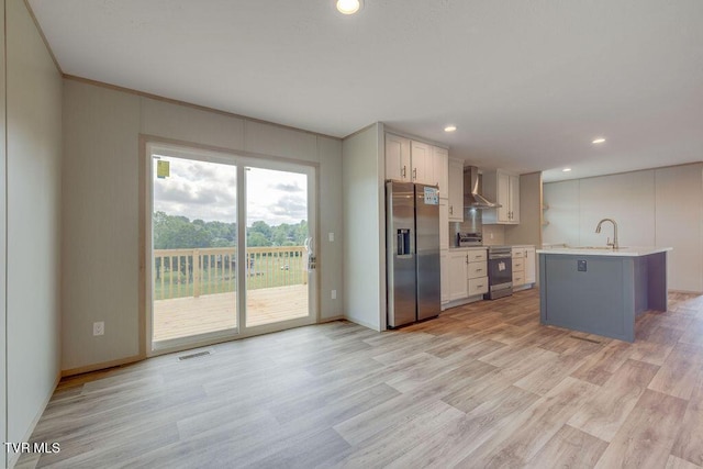 106 Iris Ln, Fall Branch, TN 37656 - kitchen featuring stainless steel appliances, light countertops, light wood-style floors, wall chimney range hood, and recessed lighting