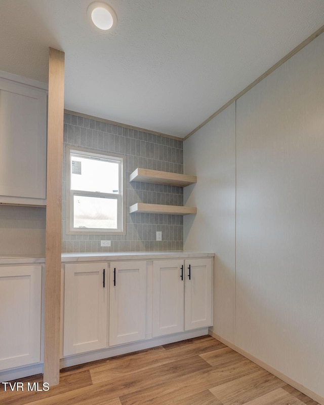 106 Iris Ln, Fall Branch, TN 37656 - kitchen with light countertops, white cabinets, light wood-type flooring, and crown molding