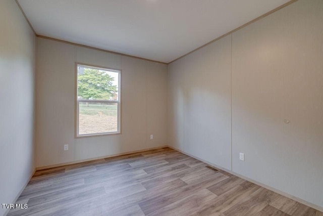 106 Iris Ln, Fall Branch, TN 37656 - spare room with ornamental molding and light wood-style flooring