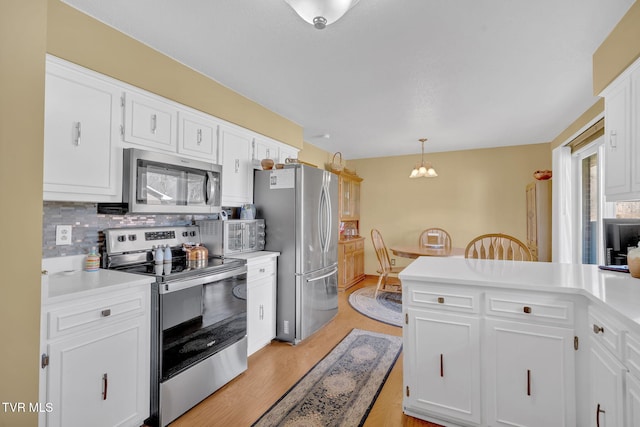520 Lyle Rd, Erwin, TN 37650 - kitchen with stainless steel appliances, light countertops, decorative backsplash, and white cabinetry