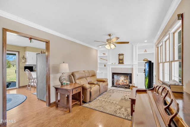520 Lyle Rd, Erwin, TN 37650 - living area with a lit fireplace, a ceiling fan, light wood-type flooring, and crown molding
