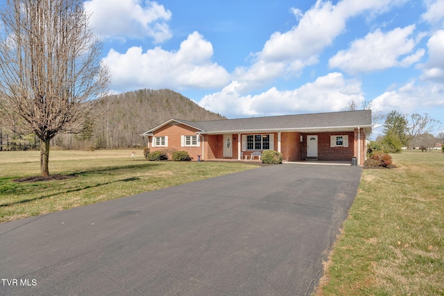 520 Lyle Rd, Erwin, TN 37650 - ranch-style house featuring an attached carport, asphalt driveway, brick siding, a mountain view, and a front yard