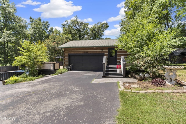 2169 Ranch Rd, Dandridge, TN 37725 - view of front facade featuring driveway, a metal roof, and a garage