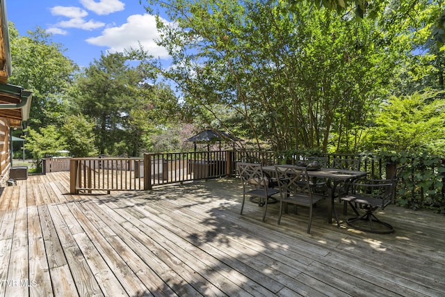 2169 Ranch Rd, Dandridge, TN 37725 - wooden terrace featuring outdoor dining area and view of wooded area