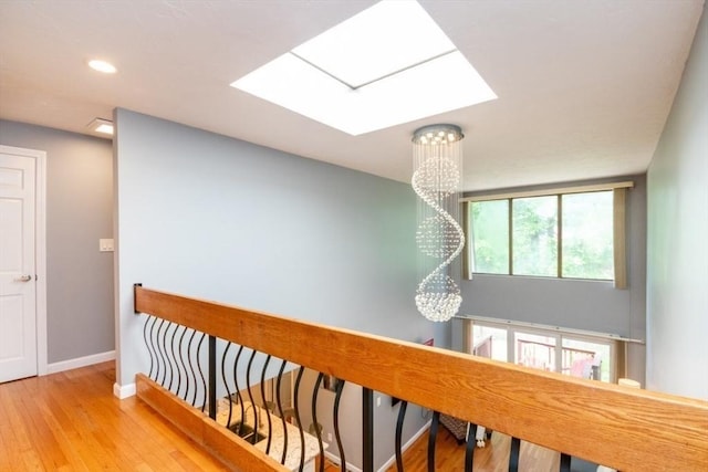10 Grove Sq Unit 10, Randolph, MA 02368 - hallway featuring a chandelier, baseboards, a skylight, hardwood / wood-style floors, and recessed lighting